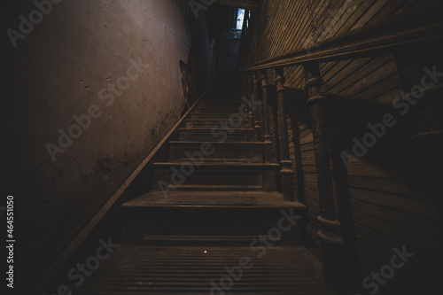 stairs of an old house lead up to darkness