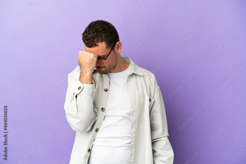 Brazilian man over isolated purple background with headache Brazilian man over isolated purple background with headache