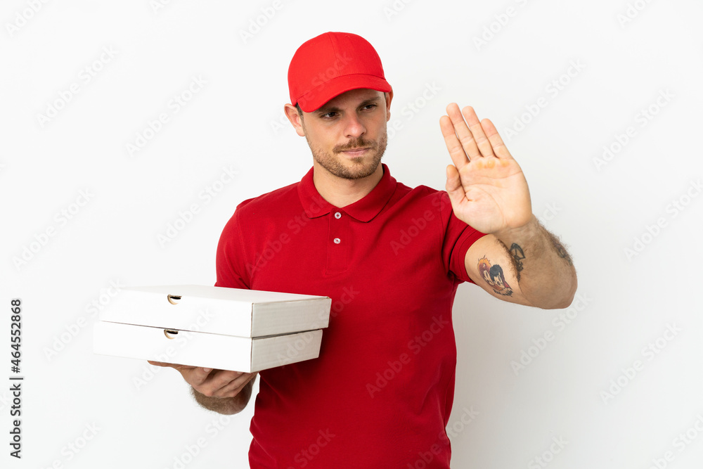 pizza delivery man with work uniform picking up pizza boxes over isolated white wall making stop gesture and disappointed pizza delivery man with work uniform picking up pizza boxes over isolated white wall making stop gesture and disappointed