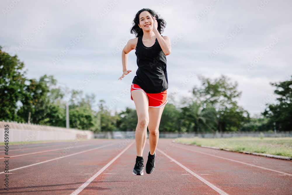 A beautiful woman runner is taking a strong stride for exercise. health care concept A beautiful woman runner is taking a strong stride for exercise. health care concept