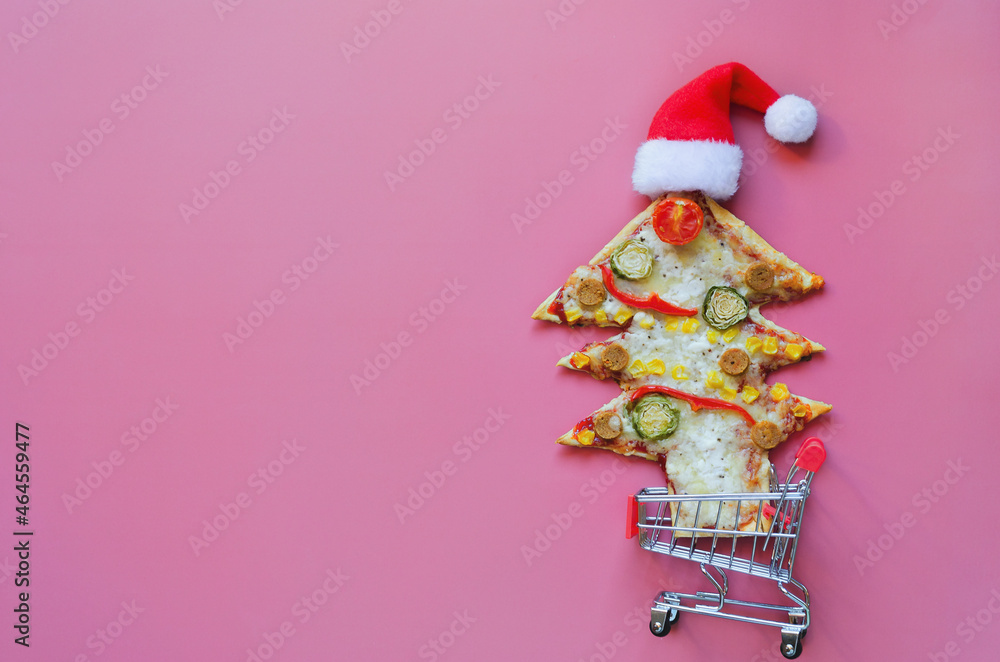 Delicious vegetarian Christmas tree pizza with tomatoes, vegetables and cheese on pink  background. Creative, funny food concept for kids. Top view, flat lay. Copy space. Template. Mock up.