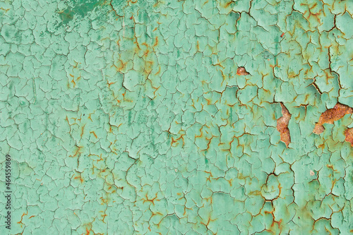 Old cracked green paint on rusty metal