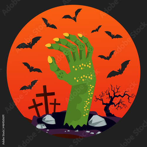 Green hand of a zombie sticks out of the ground in a cemetery