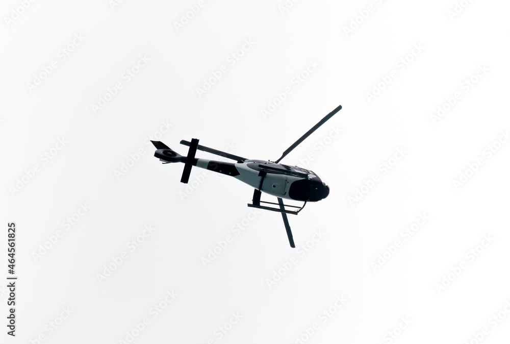 Helicopter Flying in the sky on a white background for design as a security concept and surveillance Helicopter Flying in the sky on a white background for design as a security concept and surveillance