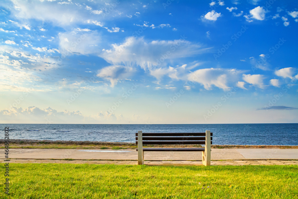 Seaside landscape - bench on the waterfront with sea view, the town of Nessebar on the Black Sea coast of Bulgaria Seaside landscape - bench on the waterfront with sea view, the town of Nessebar on the Black Sea coast of Bulgaria