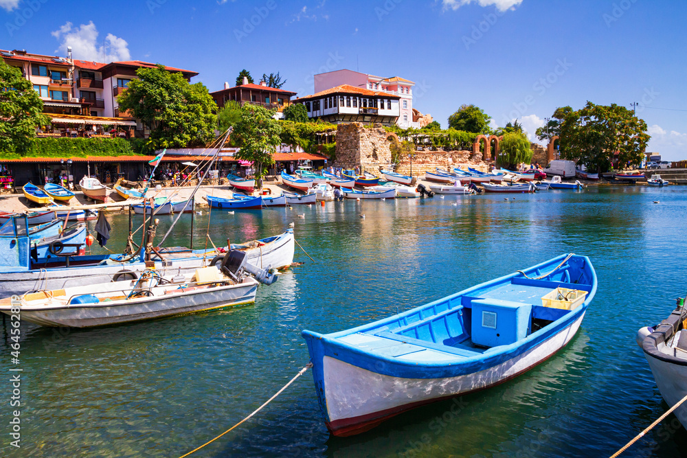 Seaside cityscape - view of the pier with boats and embankment in the Old Town of Nessebar, on the Black Sea coast of Bulgaria - obrazy, fototapety, plakaty 
