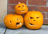 carved three halloween pumpkins, decoration and holiday concept, carved pumpkins for a fun party, funny and angry faces, jack o's lantern, halloween