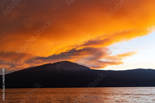 Sunset and smoke over mountain and water