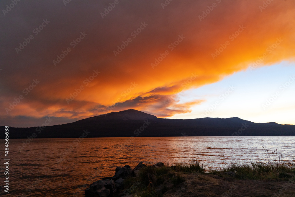 Sunset and smoke over mountain and water