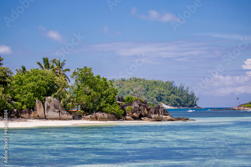 Beautiful nature of the sea tropical landscape. Exotic tropical nature of the Seychelles, a white beach surrounded by palm trees and granite rocks. © Vera