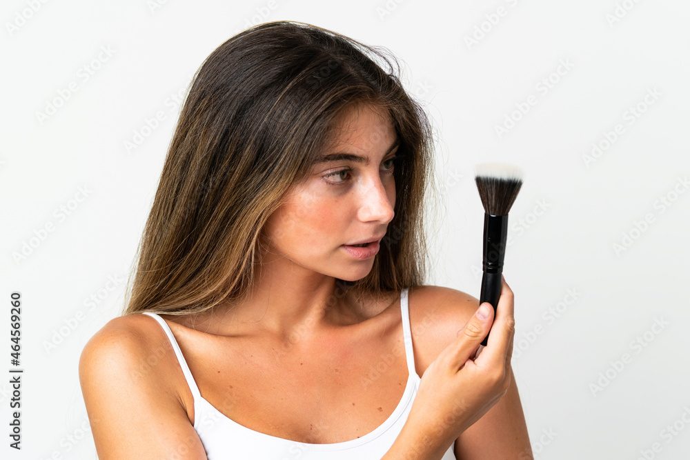 Young caucasian woman isolated on white background holding makeup brush Young caucasian woman isolated on white background holding makeup brush
