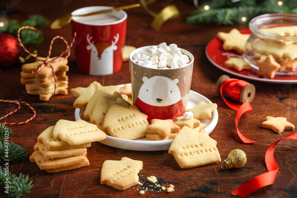 Christmas shortbread cookies with cocoa mug with marshmallows on a wooden table. Festive cookies with the words Christmas shortbread cookies with cocoa mug with marshmallows on a wooden table. Festive cookies with the words