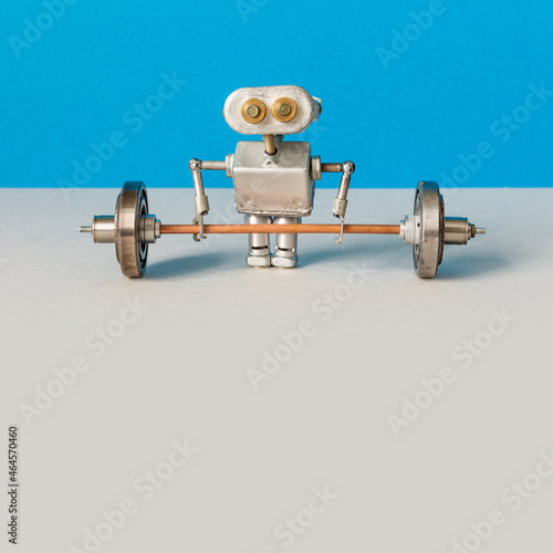 A robot weightlifter is preparing to lift a heavy barbell. Sport fitness, weightlifting and power lifting athletics workouts. blue gray background, copy space.