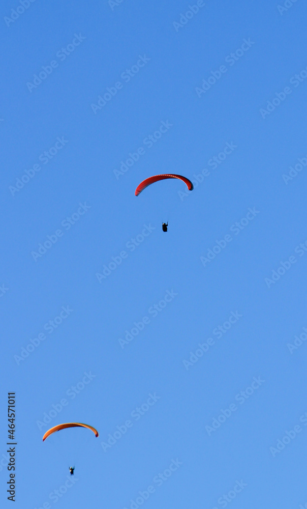 People paragliding on Santa Pola coast under blue sky People paragliding on Santa Pola coast under blue sky