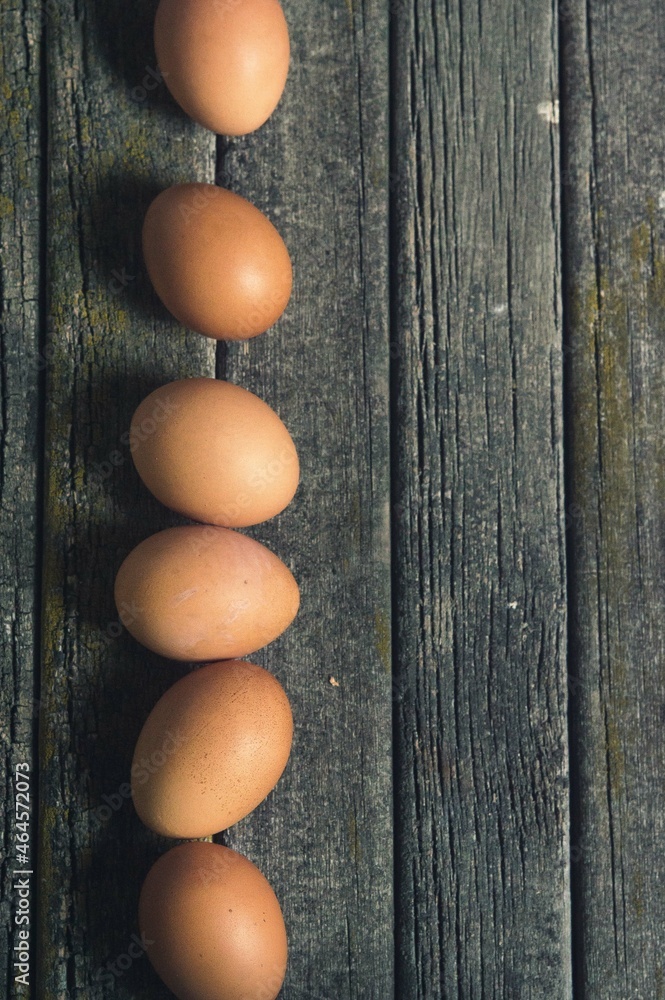 vertical placed eggs on an old wooden table vertical placed eggs on an old wooden table