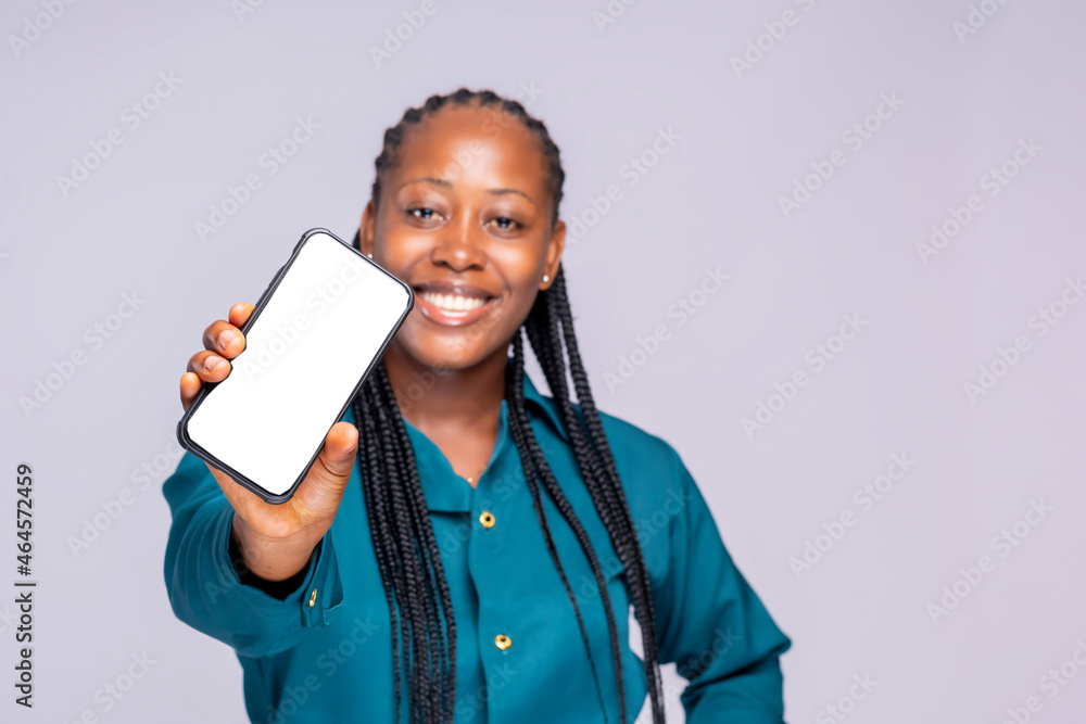 Excited Black African Lady Holding Smartphone Showing Blank Screen