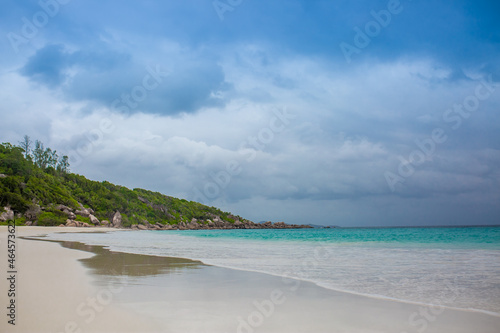 Beautiful nature of the sea tropical landscape. Exotic tropical nature of the Seychelles  a white beach surrounded by palm trees and granite rocks.