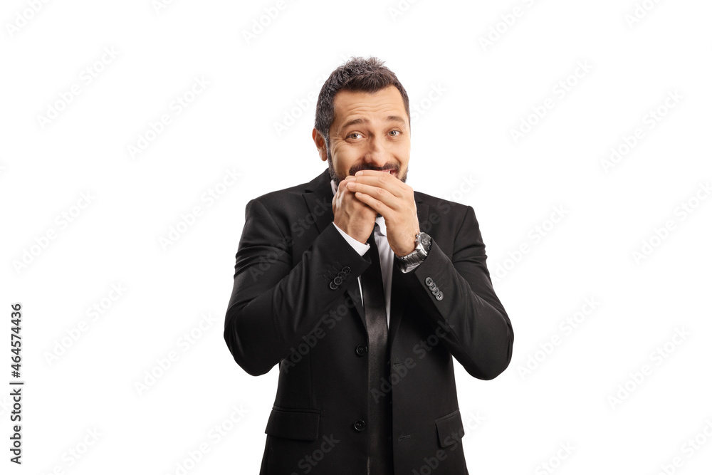 Businessman laughing and covering his mouth Businessman laughing and covering his mouth