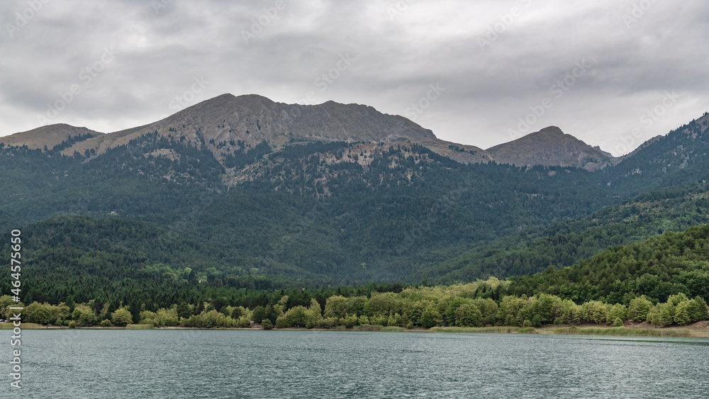 Sharp peaks surround the waters of a mountain lake Sharp peaks surround the waters of a mountain lake