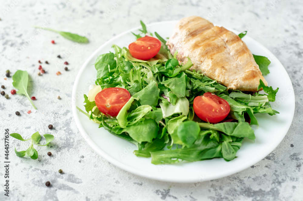 Grilled chicken breast and salad, Chicken meat with salad on a stone background. Healthy food. Grilled chicken breast and salad, Chicken meat with salad on a stone background. Healthy food.