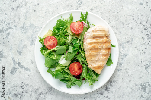 Grilled chicken breast and salad, Chicken meat with salad on a stone background. Healthy food.