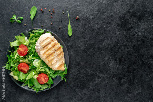 Grilled chicken breast and salad, Chicken meat with salad on a stone background. Healthy food. with copy space for your text