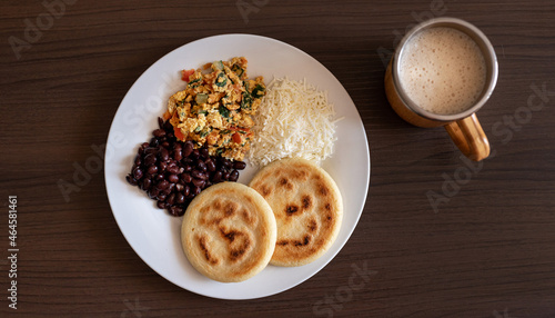 Venezuelan breakfast with arepa, white cheese, eggs and black beans