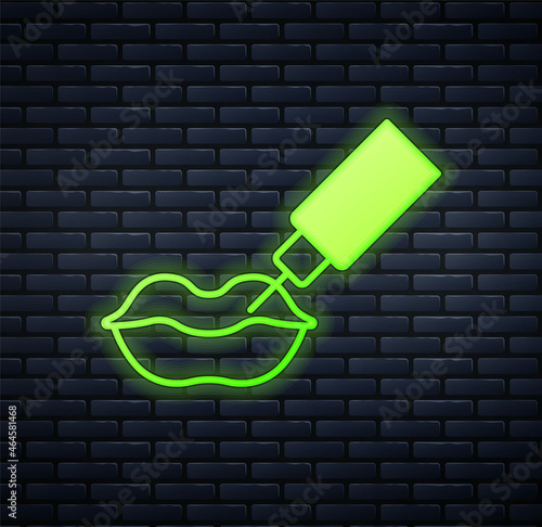 Glowing neon Lip augmentation icon isolated on brick wall background. Hyaluronic acid lips injection. Contour plastic. Vector