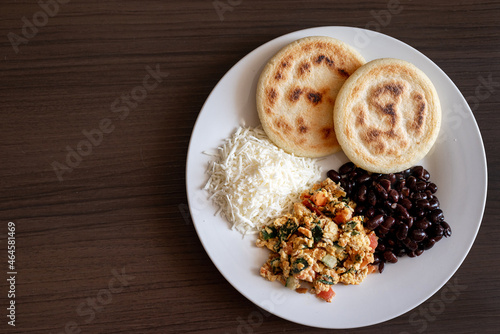 Venezuelan breakfast with arepa, white cheese, eggs and black beans