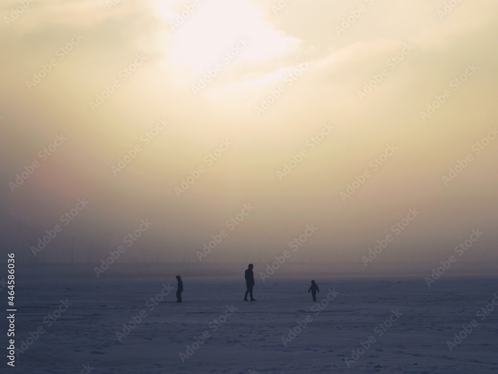Fototapeta premium Silhouettes in the distance, snow