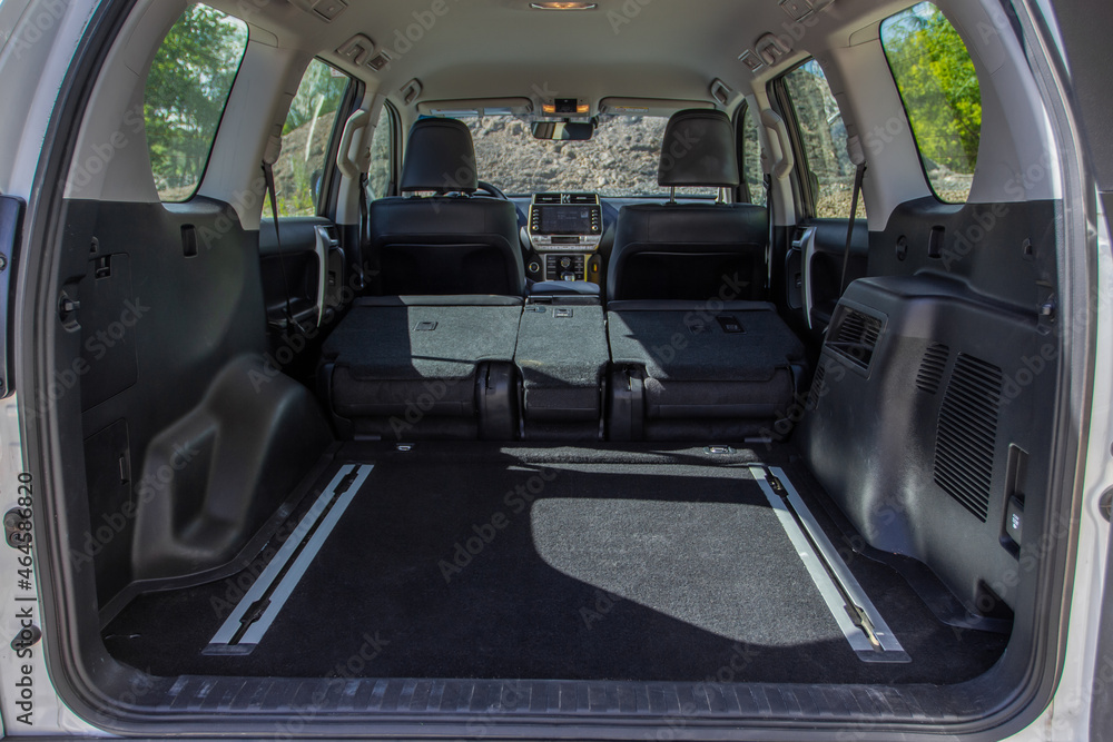 Huge, clean and empty car trunk in interior of compact suv. Rear view of a SUV car with open trunk Huge, clean and empty car trunk in interior of compact suv. Rear view of a SUV car with open trunk