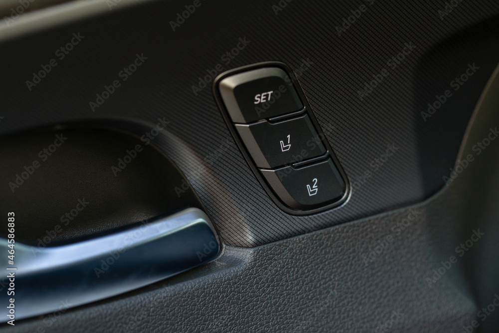 Electric car seat adjustment control panel close up view. Adjustable car seat position. Car interior.