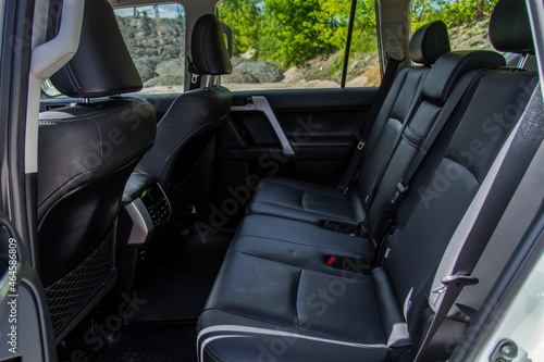 Modern SUV car inside. Leather black back passenger seats in modern luxury car. Comfortable leather seats. © Roman