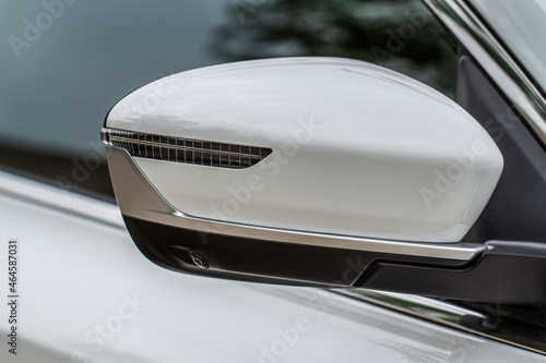 Close up front view of car side mirror. Front rear view mirror on the car window. Car exterior details.