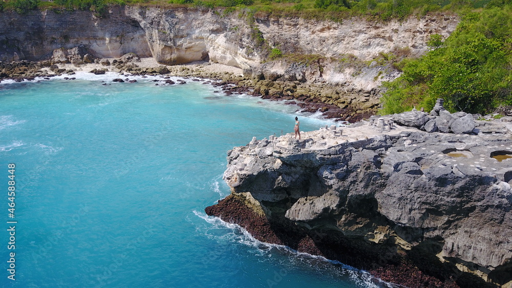 cliff jump steps ladder person woman girl ocean blue sea scenery summer relax adrenaline jumping jump in water Indonesia exotic Nusa Penida Bali island photo by drone sunny day