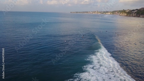 Surfing sea surf surfers group waves ocean Bali Indonesia Uluwatu beach drone view late afternoon sunset summer heat extreme sport horizon cliff nature cliff travel destination exotic