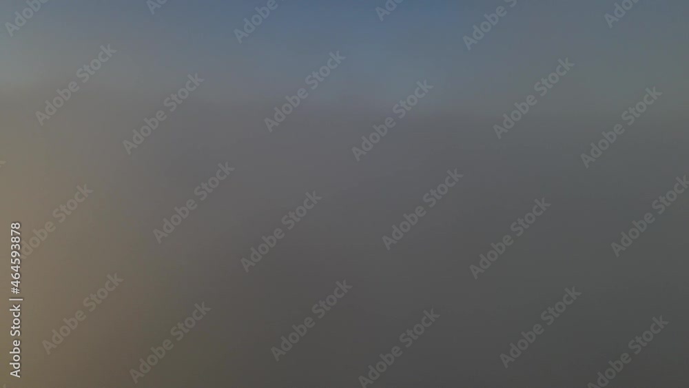 Aerial view above clouds with valley in background and wind turbines on top of mountain at sunrise, Caramulo Aerial view above clouds with valley in background and wind turbines on top of mountain at sunrise, Caramulo