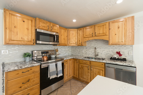 a kitchen with stainless steel appliances and wooden cabinets