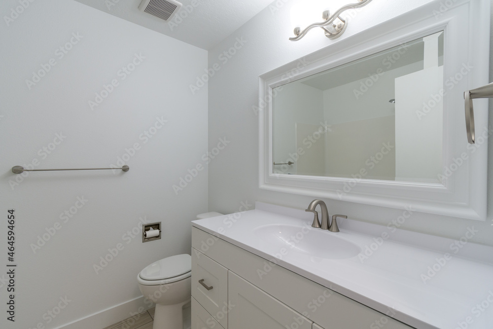 A sterile bathroom with sink, mirrored cabinets, and bathtub. A sterile bathroom with sink, mirrored cabinets, and bathtub.