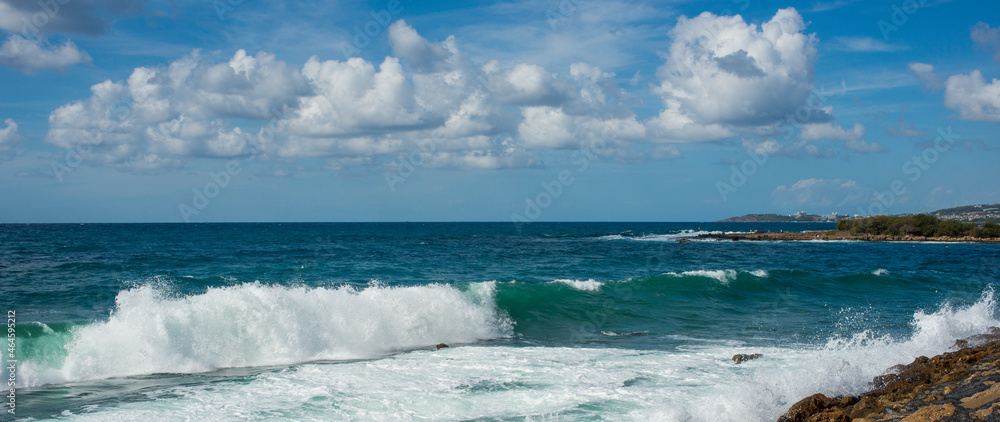 Obraz premium landscape of stormy Mediterranean sea with blue sky and white clouds and white sea foam off the coast of Turkey, Avsalar, Alanya during a storm in autumn