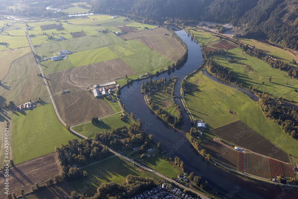 Fototapeta premium Aerial View of green Farm Field in Fraser Valley. Located in Dewdney near Chilliwack, British Columbia, Canada.
