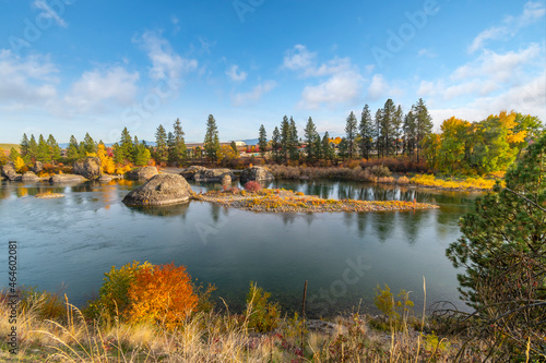 Large boulders along Spokane River as fall leaves turn colors at Autumn at Islands Trailhead along the Centennial Trail in Spokane, Washington, USA