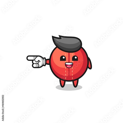 cricket ball cartoon with pointing left gesture