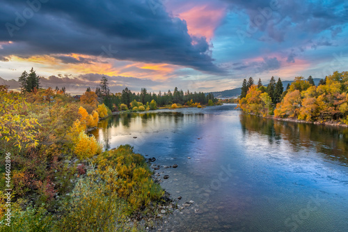 Colorful storm clouds above the Spokane River near the Barker Trail Head during Autumn, with fall colors on the leaves in Spokane, Washington, USA.
