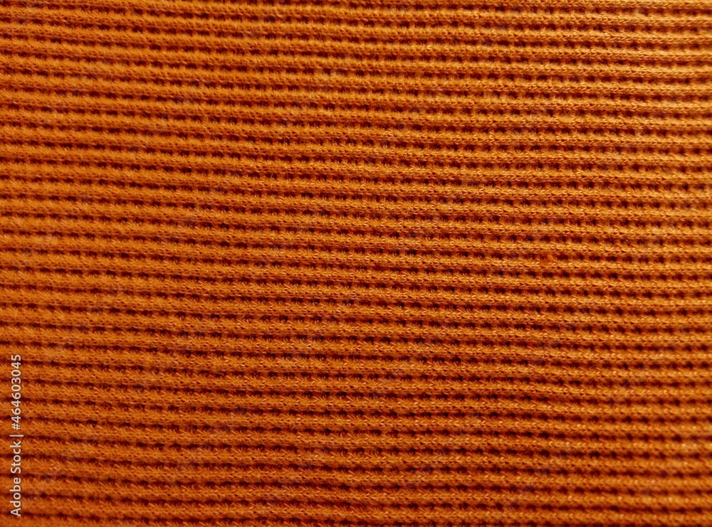 rough dark yellow or orange elastic cotton fabric surface texture background with striped groove rough dark yellow or orange elastic cotton fabric surface texture background with striped groove