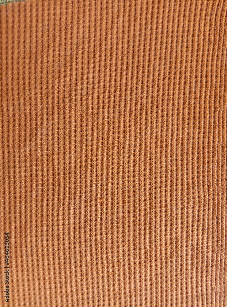 Fototapeta premium dark yellow or brown rough elastic cotton fabric surface texture background with striped groove