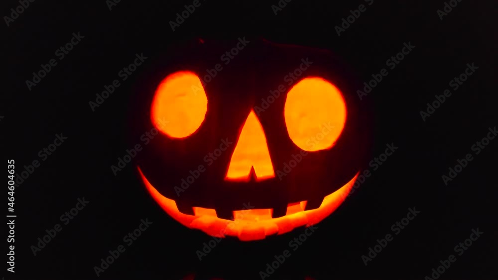 Close-up on a Jack O' Lantern glowing in the dark. Close-up on a Jack O' Lantern glowing in the dark.