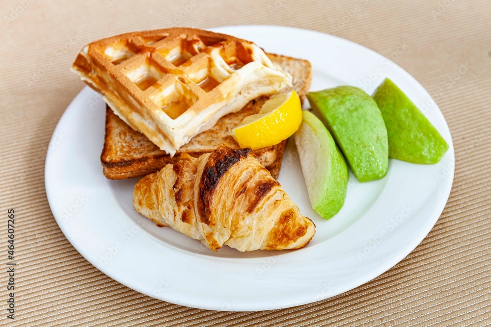 Western breakfast set plate, croissant, toast and fresh fruit Western breakfast set plate, croissant, toast and fresh fruit
