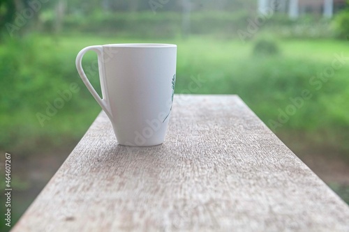 The coffee mug placed on the wood table top