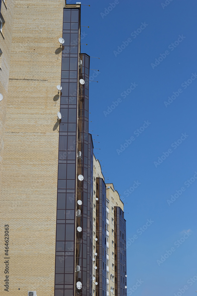 An ordinary residential high building against the blue sky, side view